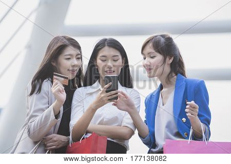 Working women chating about online shopping in the office building