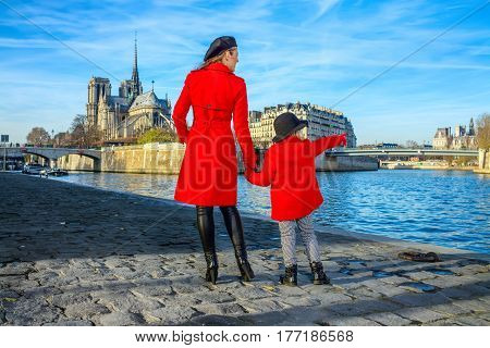 Mother And Daughter Travellers In Paris Pointing At Something