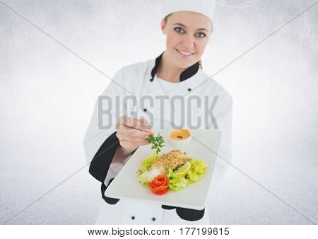 Digital composite of Chef with plate of food against white background