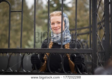 Beautiful Red-haired Girl Behind Forged Fence