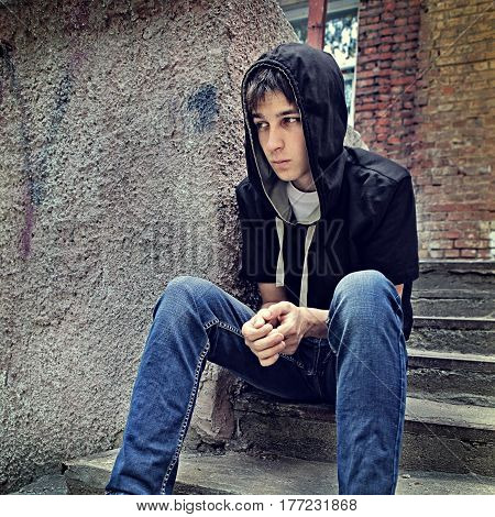 Toned Photo of Sad and Anxious Teenager on the City Street