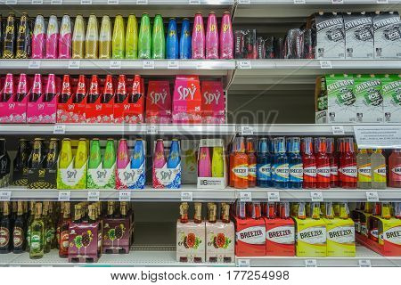 BANGKOK, THAILAND - FEBRUARY 10, 2017 : Shelves with bottles low alcohol drinks selling of Spy, Breezer in Tesco lotus supermarket. Tesco is the world's second largest retaile