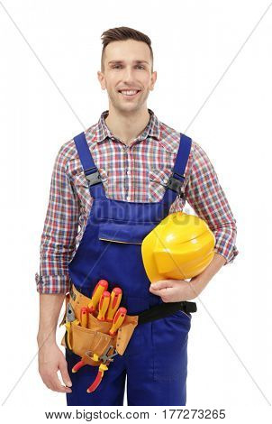 Young electrician with tools and helmet on white background