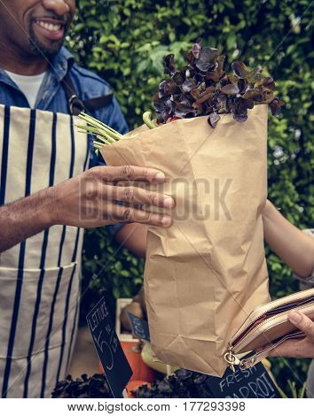 People Buying Vegetable From Shop at Market