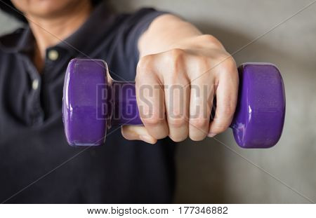 Woman Hand Holding Violet Dumbbell stock photo