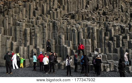 REYNISFJARA, ICELAND - 03 MAR - Groups of tourist enjoying at Reynisfjara Beach, South Iceland in weekend holidays, on 03 March, 2017