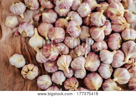 Close-up Garlic Bulbs And Garlic Cloves On Wodeen Background. Ga