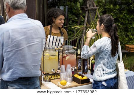Adult Women Selling Lemonade to Customer at Food Stall Market