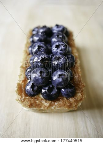 Close up blueberry tart on the wooden board