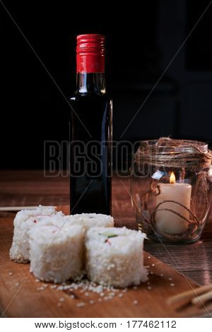 Japanese food sushi roll with crab sesame seeds cucumber cheese on a wooden board svea in the background