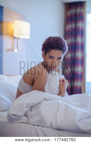 Young Black Woman Seat In Bed.