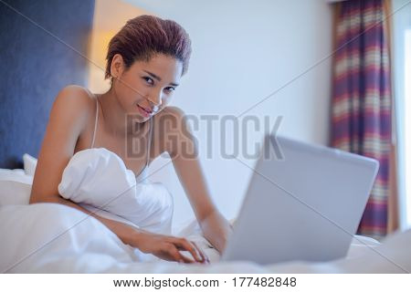 Young Black Woman Seat In Bed.