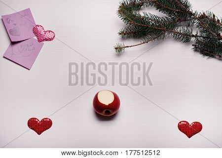 Wooden White Background With A Branch Of Pine And Three Hearts.