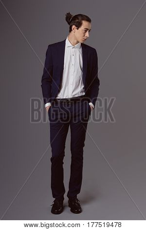 Business fashion man wearing blue suit with white shirt. Studio shot against grey. Processed with VSCO s3 preset