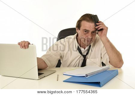 sad and stressed businessman on his 40s with loose tie and messy look gesturing desperate overworked and overwhelmed in busy tired and exhausted office work and business stress