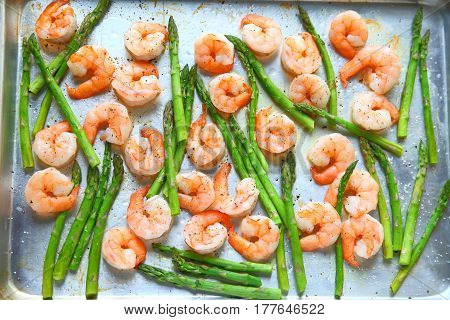 Sheet pan dinner of shrimp and asparagus with olive oil and black pepper
