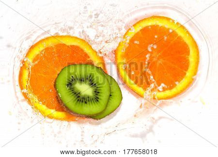 orange and kiwi in water white . 