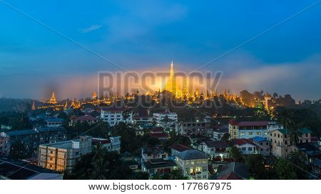 Shwedagon Paya pagoda in Gold Mist in the morning before sunrise .Myanmar famous sacred place and tourist attraction landmark.Yangon Myanmar