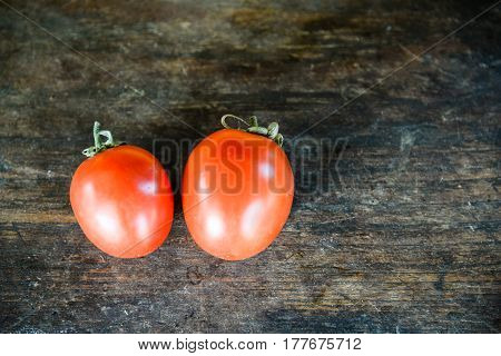 fresh tomatoes on the wood table background copy space
