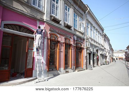 Novi Sad, Serbia: march 1. 2017 - Man painting the walls in Old town in Novi Sad - Serbia