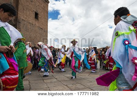 Cuzco Peru - December 25 2013: Man wearing traditional clothes and masks dancing the Huaylia in the Christmas day in front of the Cuzco Cathedral in Cuzco Peru.