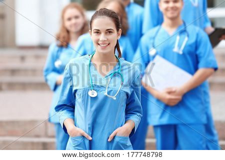 Young student with groupmates outdoors