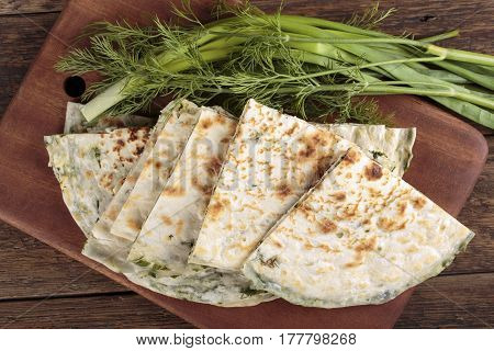 Scallion pancakes. Round unleavened flatbread minced green onions and dill. Top view.