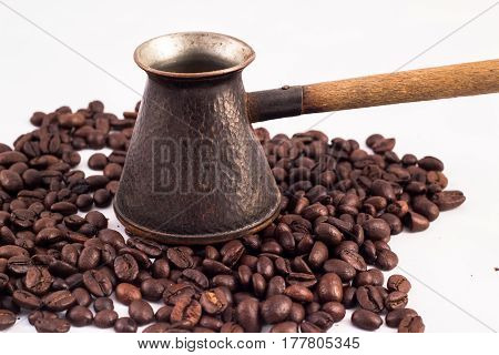 Armenian Jazva, Small Pot For Making Coffee. Many Coffee Beans In The Background. Texture Of The Cof