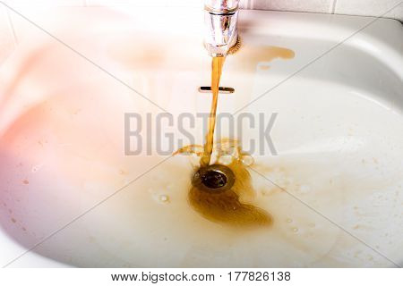 Dirty Brown Water Running Into A Sink