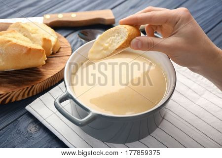 Woman eating delicious cream soup