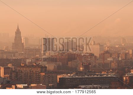 Close-up shooting from high point of metropolitan city: residential buildings and districts illuminated by morning sun tower multiple facades and windows Government building hazy horizon Moscow