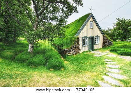 A Small Wooden Church And Cemetery Hofskirkja Hof, Skaftafell Iceland. Scenic Sunset Through Tree Cr