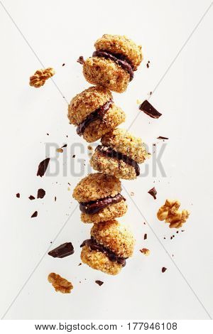 Chocolate Walnut Cookies. Walnut sandwich cookies sticked together with creamy rich dark chocolate fudge. 