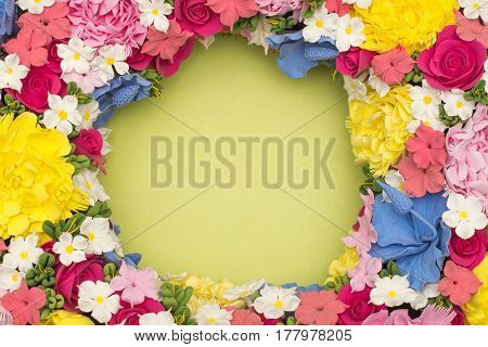 Green background with red, pink, white, purple flowers in a circle. Postcard for the holiday (Mother's Day, Easter, birthday, congratulations, Valentine's Day). Place for writing (letters).