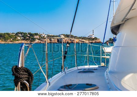 Idyllic View Of Lighthouse In Porto Colom From Marina, Mallorca Island, Spain Mediterranean Sea