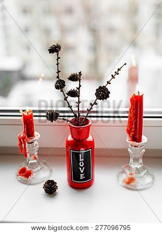 St. Valentine's Red Candles On The Windowsill
