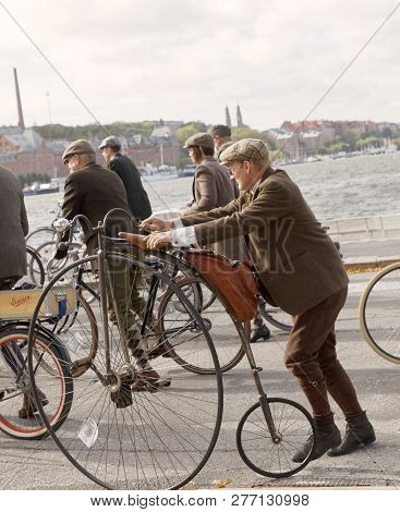 Stockholm - Sept 22, 2018: Senior Man Wearing Old Fashioned Tweed Suit Holding A High Wheeler Bicycl