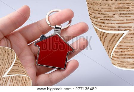 Hand Holding A House Icon In Hand On A Background