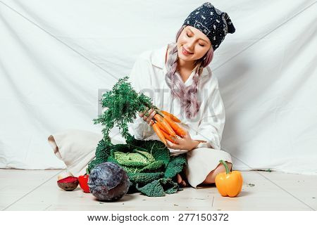Beautiful Caucasian Vegan Woman With Vegetables Sitting On A Flooor. Spring Time Concept And Healthy