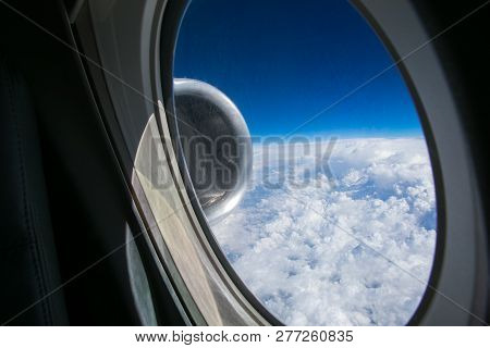 View From The Window Of The Plane Onto The Wing And Engines Of A Fokker 100 Model With A Blue Sky An