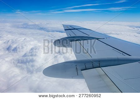 View From The Window Of The Plane Onto The Wing And Engines Of A Fokker 100 Model With A Blue Sky An