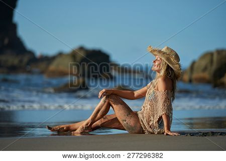 young woman relaxing on the beach in summer day