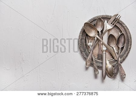 Vintage Silver Spoons, Forks And Knife On Vintage White Background. Copy Space