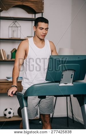 Strong Muscular Bi-racial Man Exercising On Treadmill In Living Room