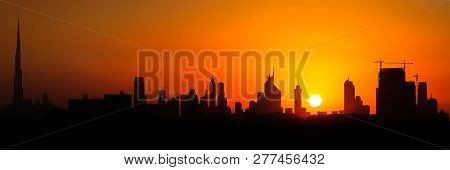 Sun Goes Down Over Dubai Skyscrapers As Beautiful Sunset In Middle East.