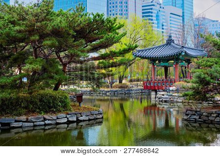 Yeouido Park public park pond with pavilion summerhouse in Seoul, Korea