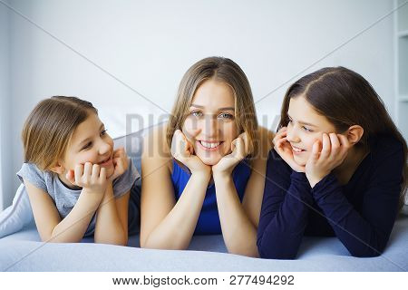 Mother And Daughter Enjoy In Bed At Home