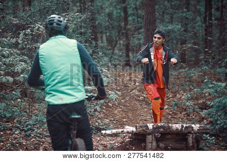 Moscow, Russia - Nov, 2018: MTB teacher helping rider learn to ride bicycle. Teaching a rider to rid