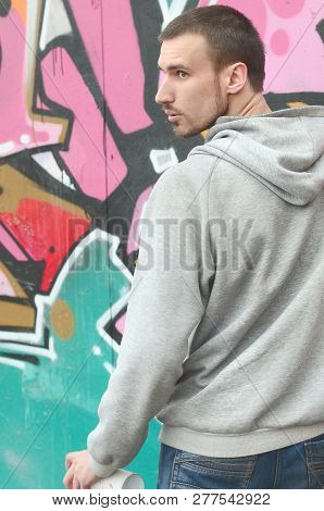 A Young Graffiti Artist Looks Around While Drawing. Vandal Tries
