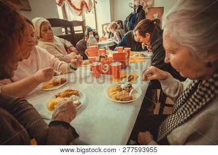 Kyiv, Ukraine - Jan 7: Older Poor Women Having Food At The Christmas Charity Dinner For The Homeless